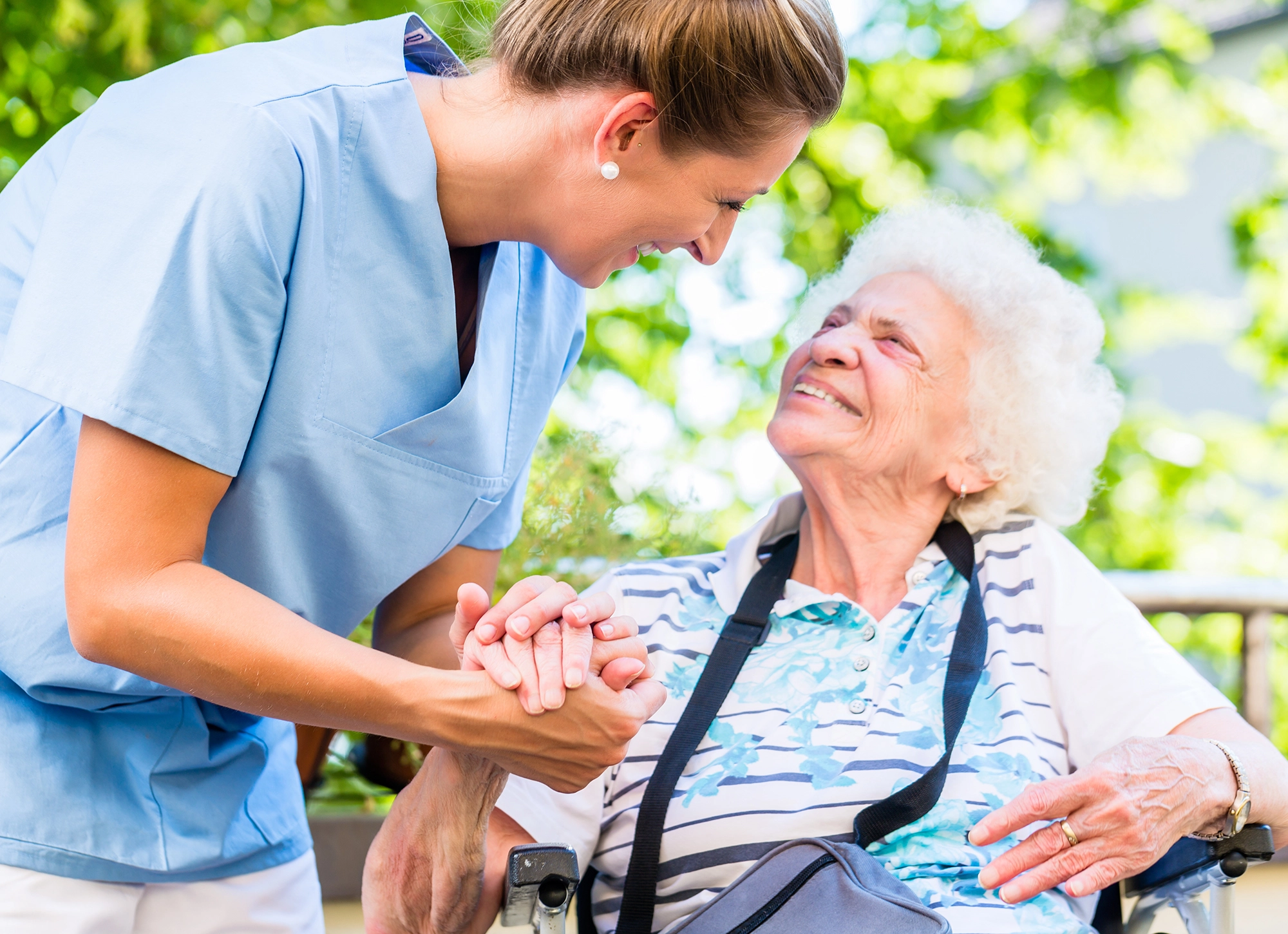 Whitney Place senior women resident outside on a excursion with a SALMON Health and Retirement staff member