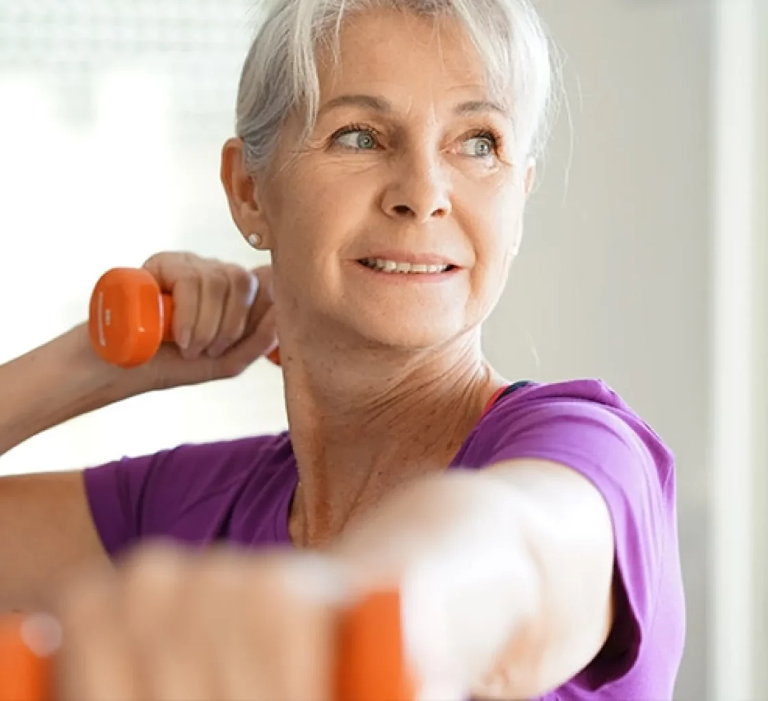 senior woman working out with dumbbells