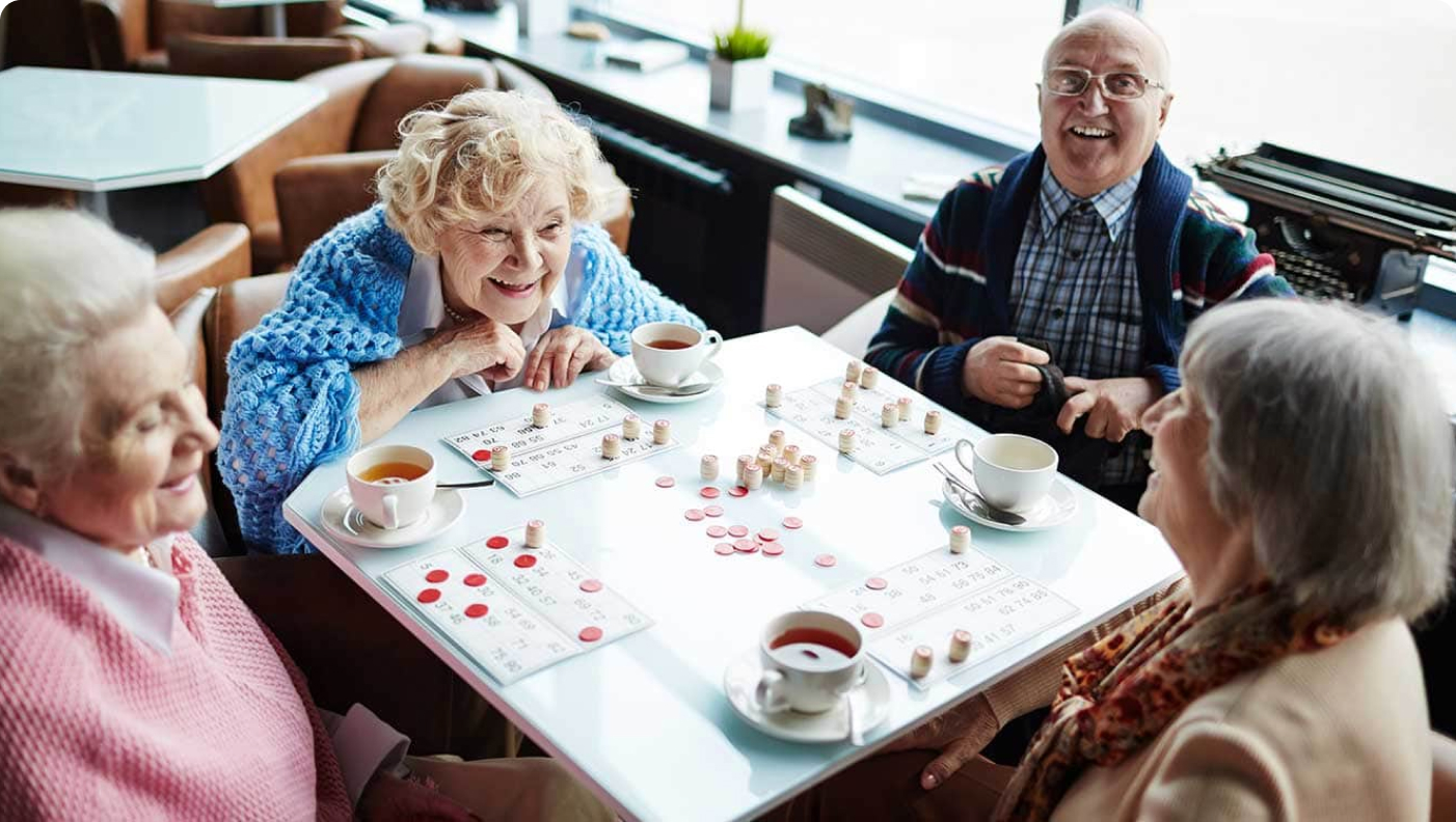 Seniors drinking tea while playing bingo at SALMON Health and Retirement
