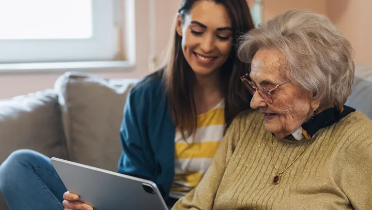 elder daughter and senior mother looking at SALMON's website on a iPad