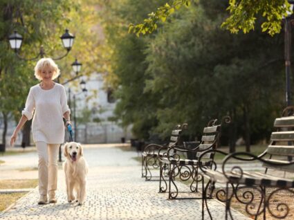 senior woman walking her dog