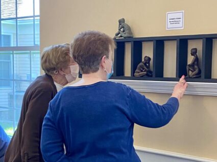 Two Women viewing artwork