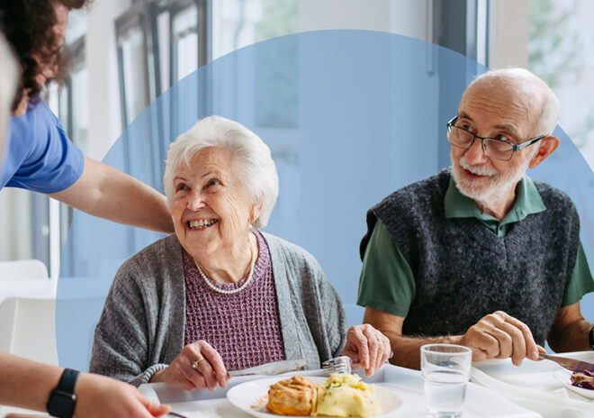 caregiver serving lunch to senior couple v2