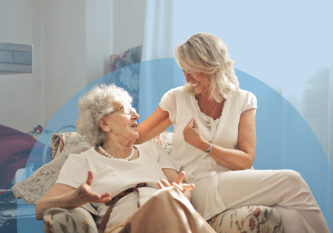 caregiver smiling and talking with senior resident