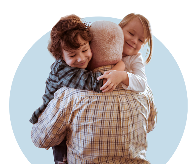 senior man holding grandchildren
