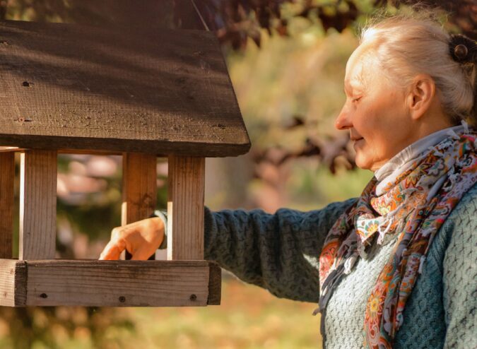 Senior Resident Tending to Birdhouse