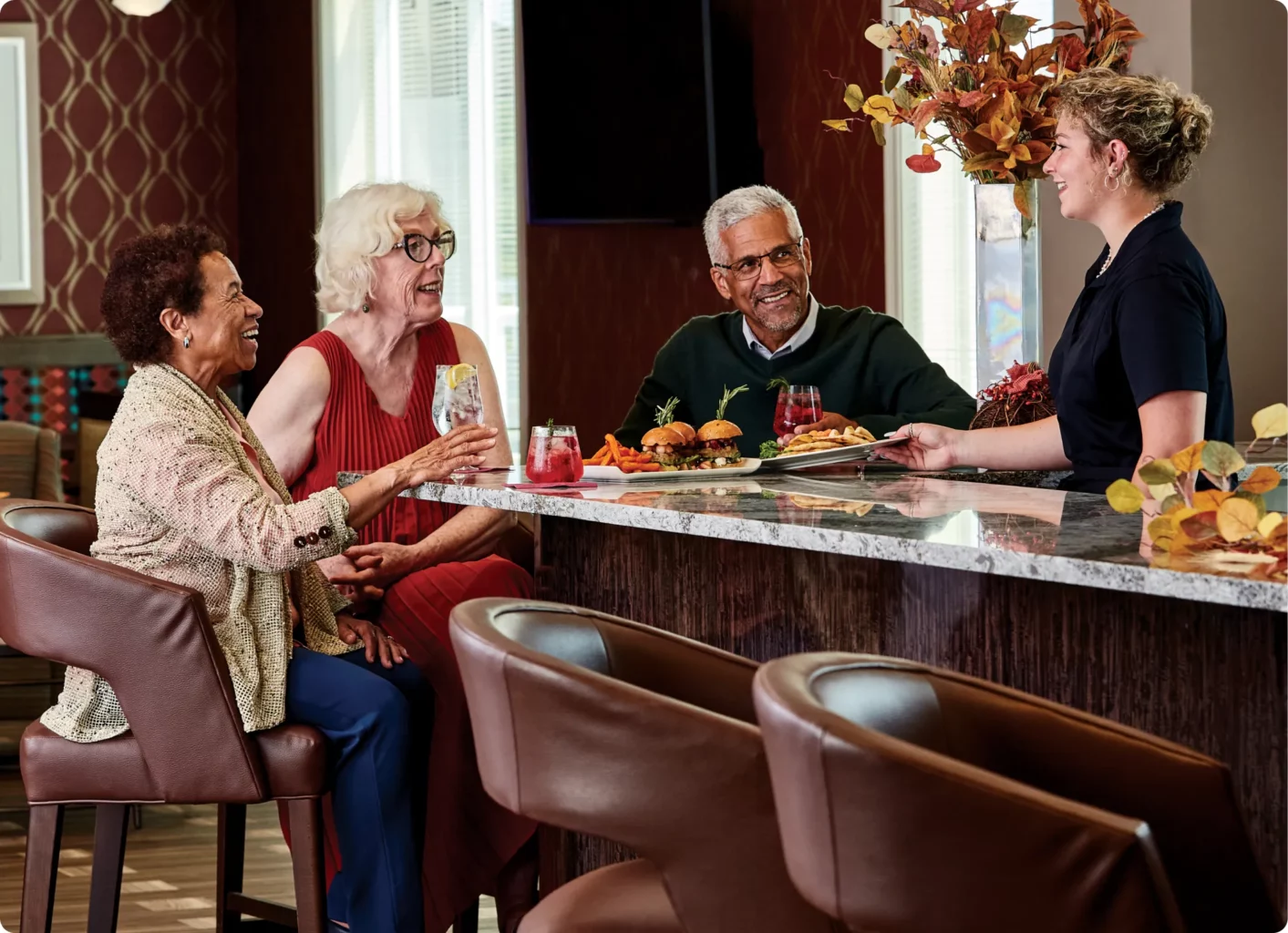 Senior friends enjoying food and drinks at The Willows at Medway O'Toole's Lounge and Bar