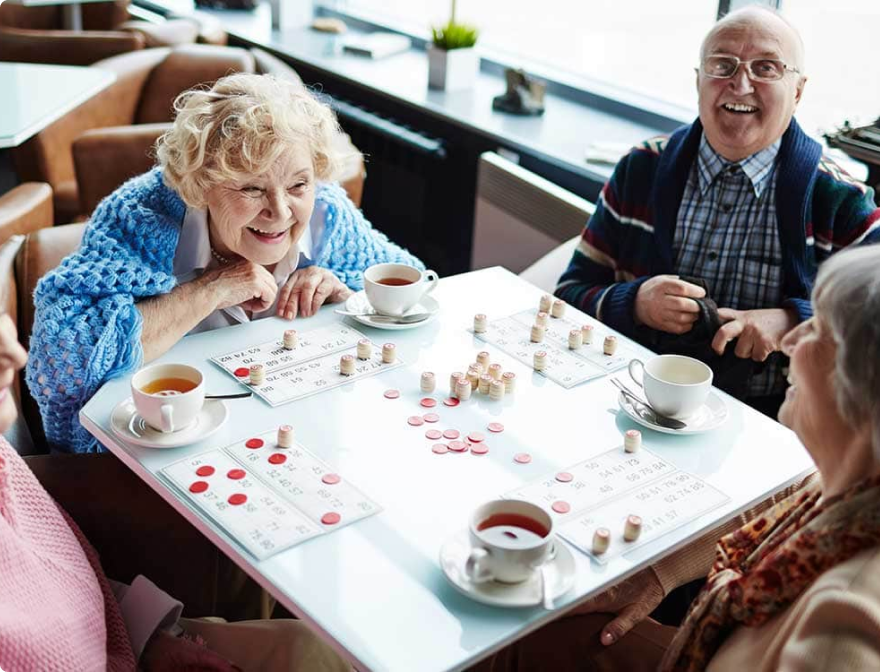Seniors drinking tea while playing bingo at SALMON Health and Retirement