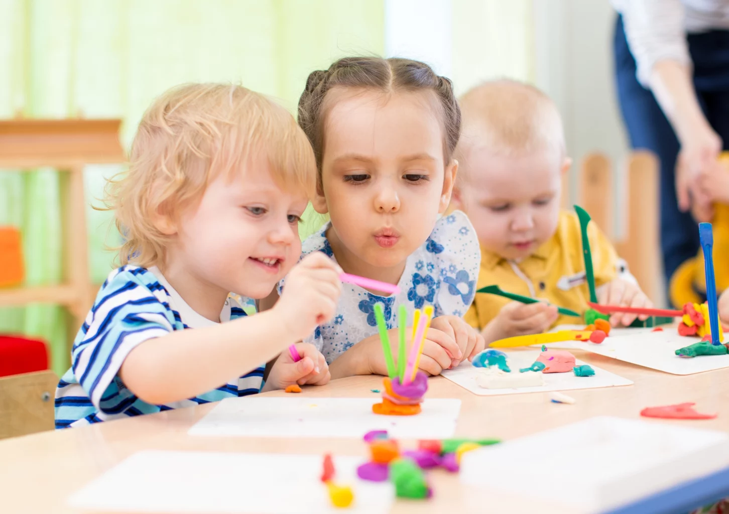 Two little girls drawing a butterfly at the SALMON Health and Retirement's Centers for Early Education Natick