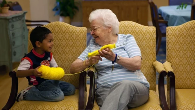 Senior women knitting with a young boy
