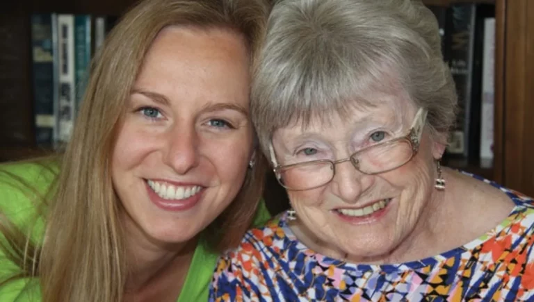 Elder daughter and senior mother smiling