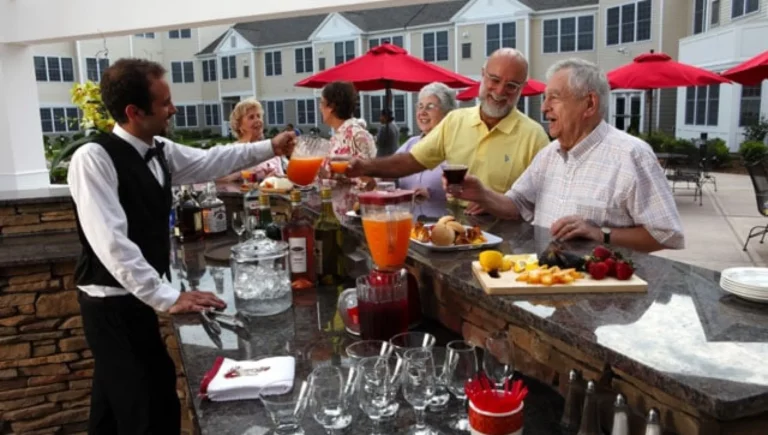 SALMON at Worcester The Willows outdoor event with residents being served drinks by a bartender